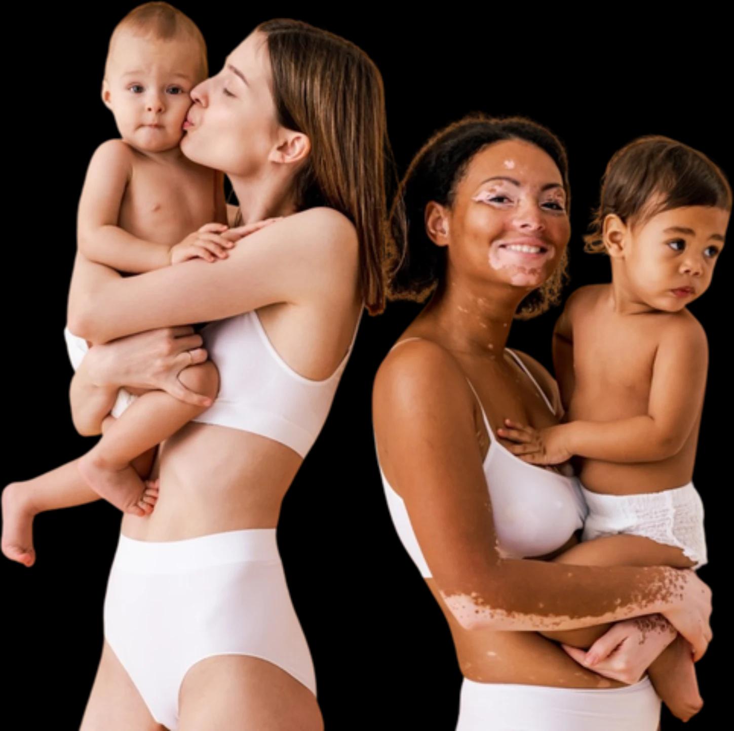 Two mothers holding their babies, one kissing her baby’s cheek